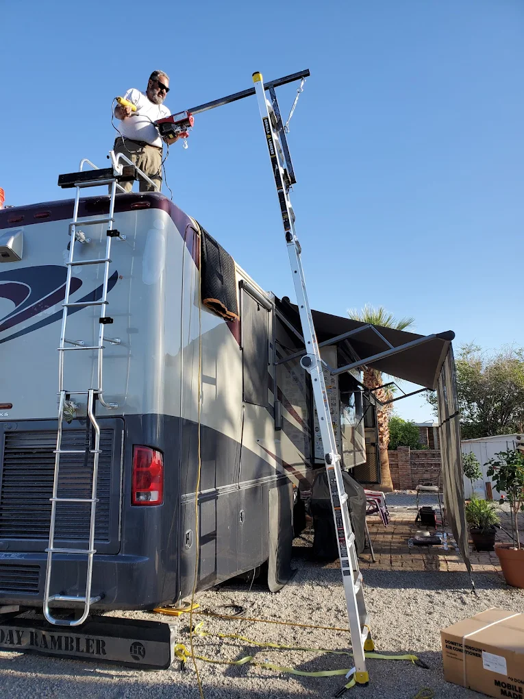 Mark installing a rooftop RV air conditioner using a lifting crane
