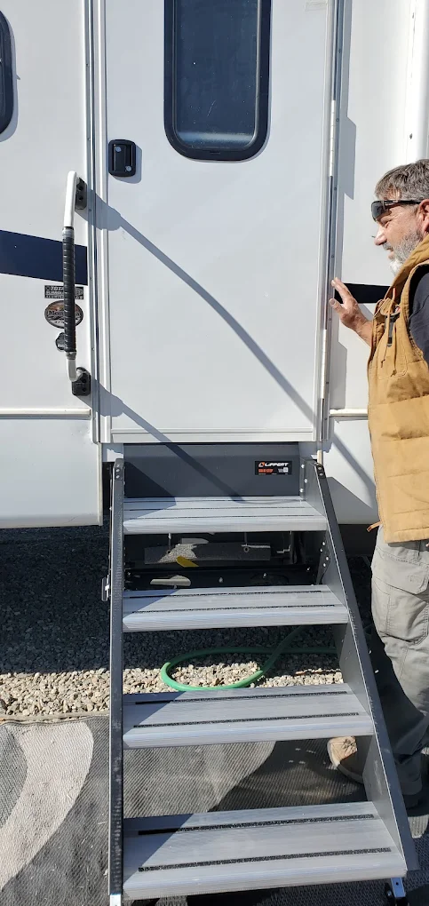 Mark inspecting a newly installed RV door and entry steps